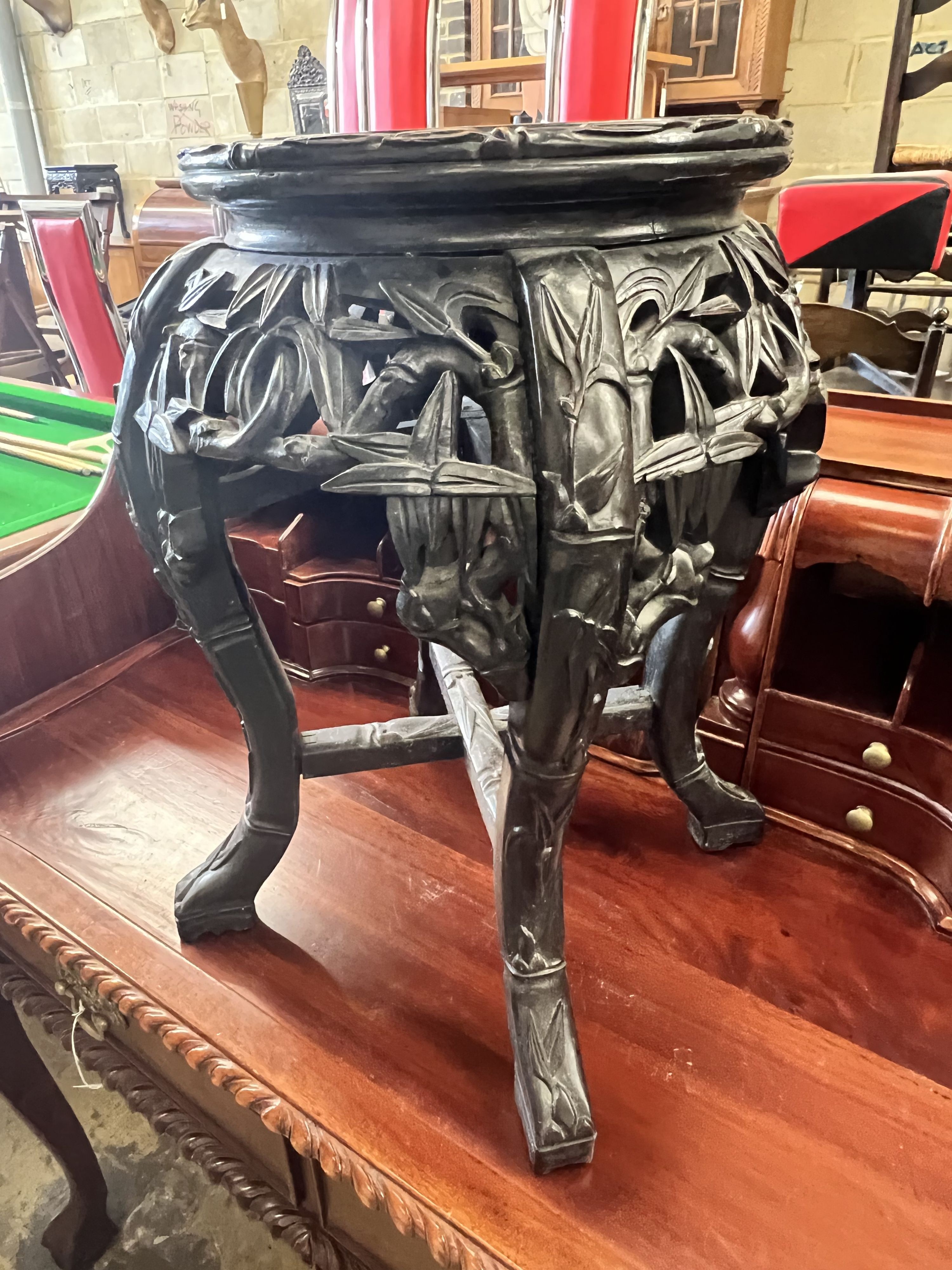 A Chinese carved hardwood circular marble topped vase stand, width 32cm height 47cm